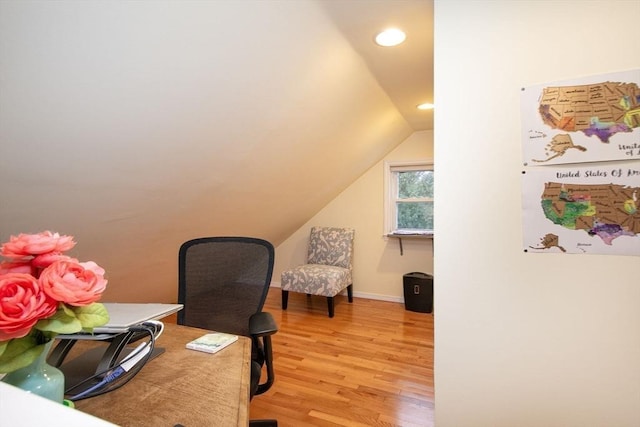 home office featuring hardwood / wood-style floors and vaulted ceiling