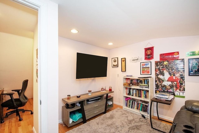 living room with lofted ceiling and hardwood / wood-style flooring