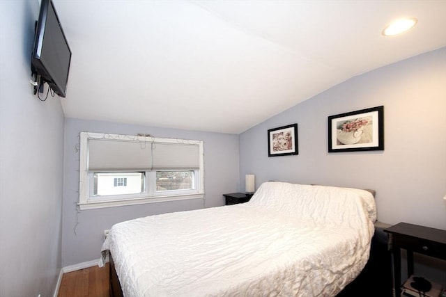 bedroom featuring dark hardwood / wood-style floors and vaulted ceiling