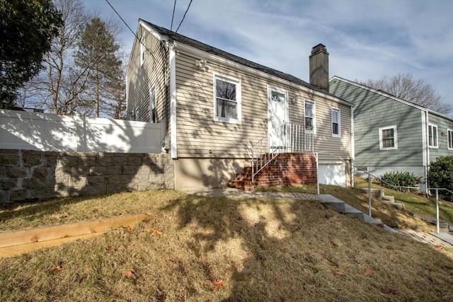 rear view of property with a lawn