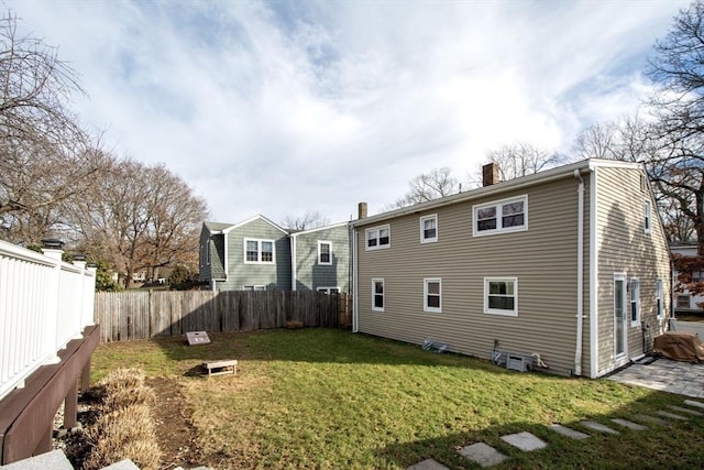 back of house featuring a yard