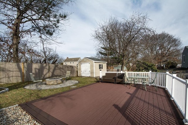 deck featuring a storage unit and an outdoor fire pit