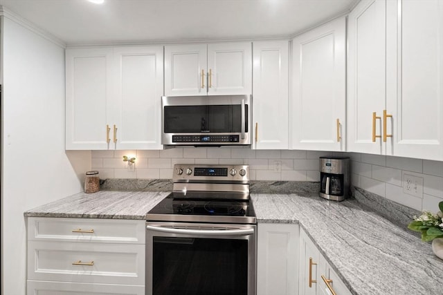 42 2nd Ave Unit 40, North Attleboro, MA 02760 - kitchen with stainless steel appliances, white cabinetry, decorative backsplash, and light stone counters