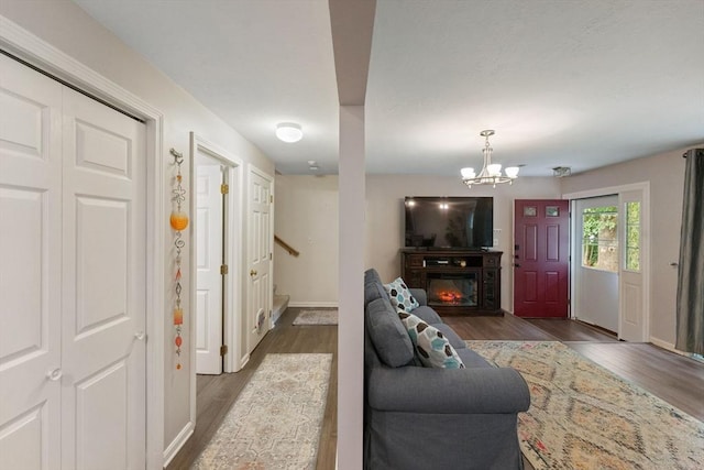 42 2nd Ave Unit 40, North Attleboro, MA 02760 - living area with wood finished floors, a glass covered fireplace, a chandelier, and stairway