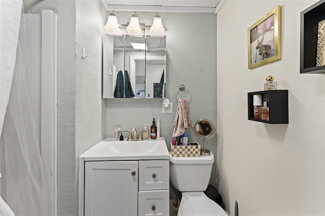 bathroom featuring toilet and vanity