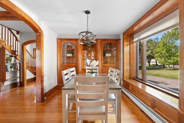 3 Scotland Heights Rd, Haverhill, MA 01832 - dining area with a baseboard radiator, a chandelier, light wood-style floors, stairway, and baseboards