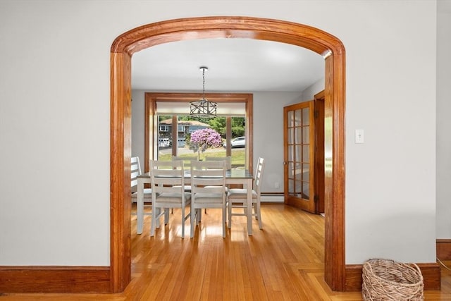 3 Scotland Heights Rd, Haverhill, MA 01832 - dining room featuring arched walkways, a baseboard heating unit, light wood-style floors, and baseboards