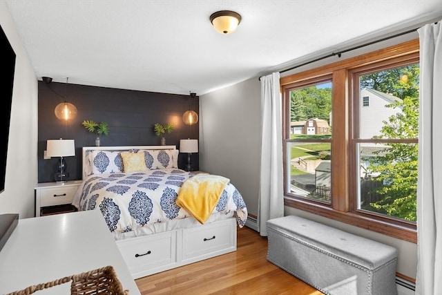 3 Scotland Heights Rd, Haverhill, MA 01832 - bedroom featuring light wood-style flooring, an accent wall, and baseboard heating
