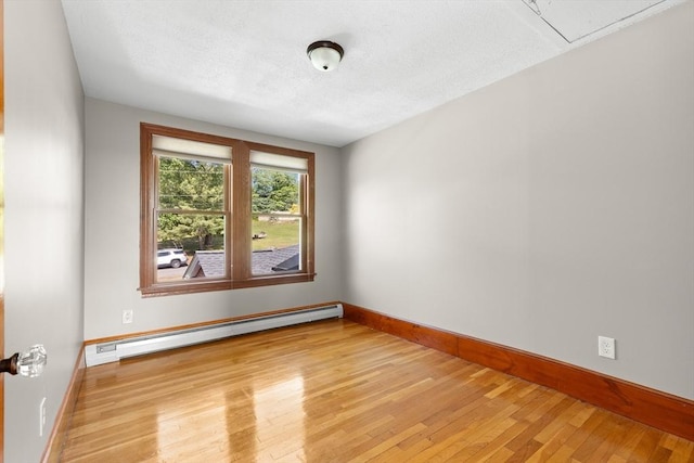 3 Scotland Heights Rd, Haverhill, MA 01832 - spare room with a baseboard heating unit, baseboards, light wood-type flooring, and a textured ceiling