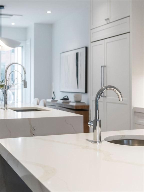 559 E Broadway Unit 559, Boston, MA 02127 - kitchen with light stone counters, white cabinets, and recessed lighting