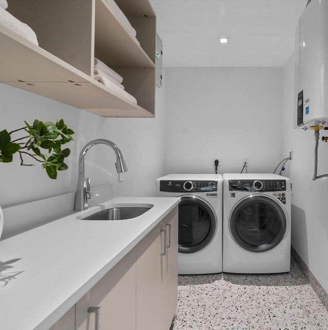 559 E Broadway Unit 559, Boston, MA 02127 - laundry room featuring washing machine and clothes dryer, tankless water heater, and cabinet space