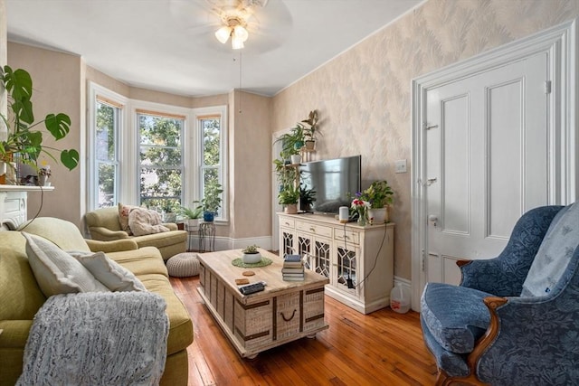 109 Eutaw St, Boston, MA 02128 - living room with ceiling fan, light wood-style flooring, baseboards, and wallpapered walls