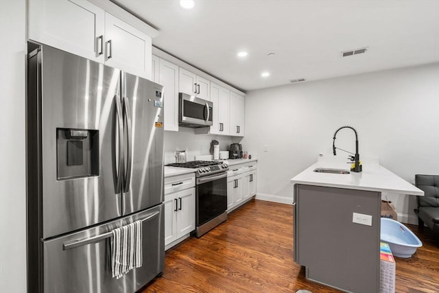 109 Eutaw St, Boston, MA 02128 - kitchen with visible vents, a breakfast bar area, appliances with stainless steel finishes, and a sink