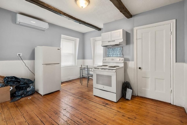 109 Eutaw St, Boston, MA 02128 - kitchen featuring white appliances, light wood-style flooring, an AC wall unit, beamed ceiling, and white cabinets