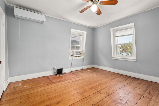 109 Eutaw St, Boston, MA 02128 - spare room with a ceiling fan, an AC wall unit, baseboards, cooling unit, and hardwood / wood-style flooring