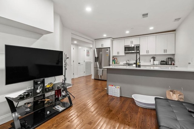 109 Eutaw St, Boston, MA 02128 - kitchen featuring wood finished floors, white cabinets, visible vents, and appliances with stainless steel finishes