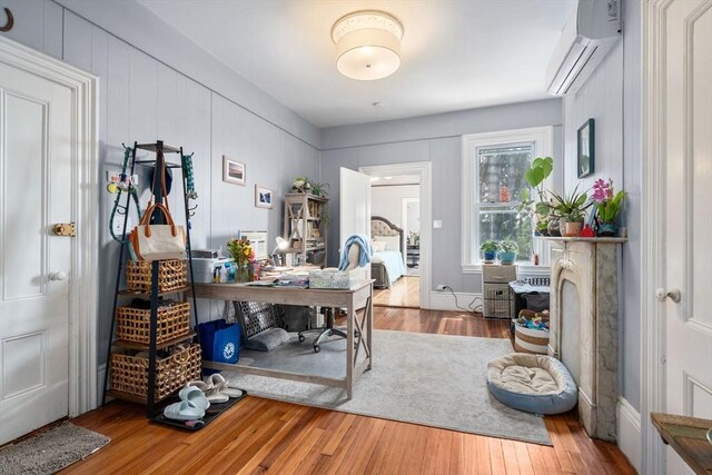 109 Eutaw St, Boston, MA 02128 - office area featuring a wall unit AC and wood finished floors