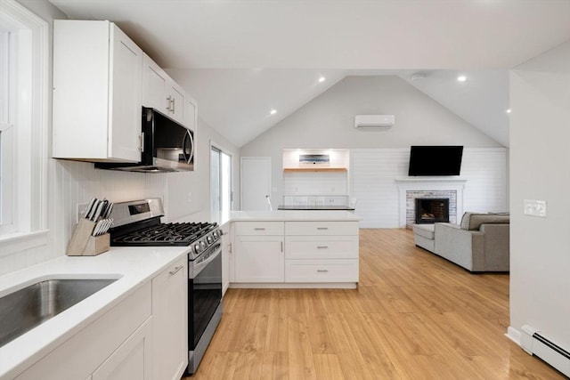 kitchen featuring white cabinetry, light countertops, baseboard heating, and stainless steel appliances