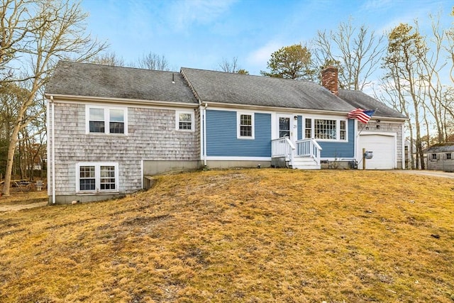 view of front of home featuring a front lawn, a chimney, a garage, and roof with shingles