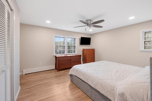 bedroom featuring baseboards, light wood finished floors, recessed lighting, ceiling fan, and a baseboard heating unit