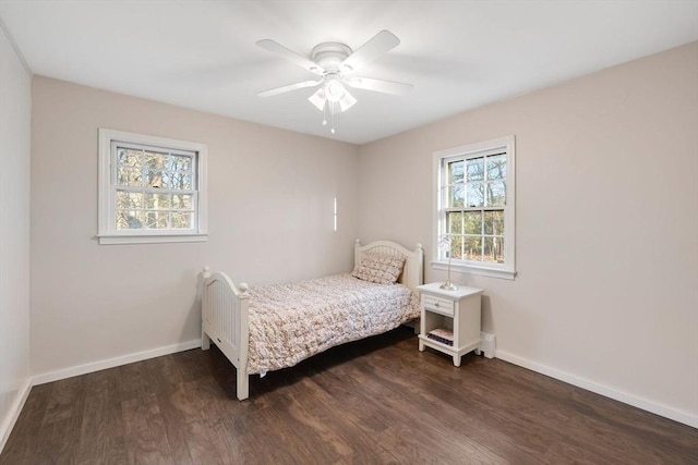 bedroom with baseboards, ceiling fan, and dark wood-style flooring