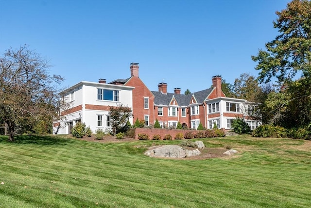 rear view of property with a yard