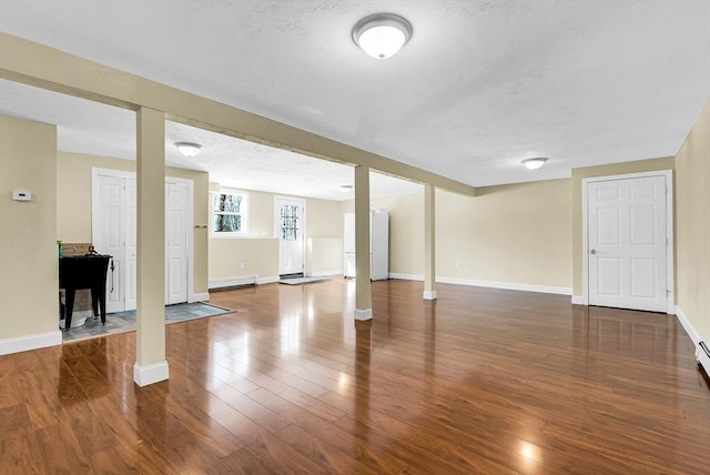 interior space featuring wood-type flooring and a baseboard radiator