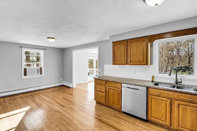 kitchen featuring light stone counters, light hardwood / wood-style floors, dishwasher, and sink