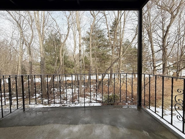 view of snow covered back of property