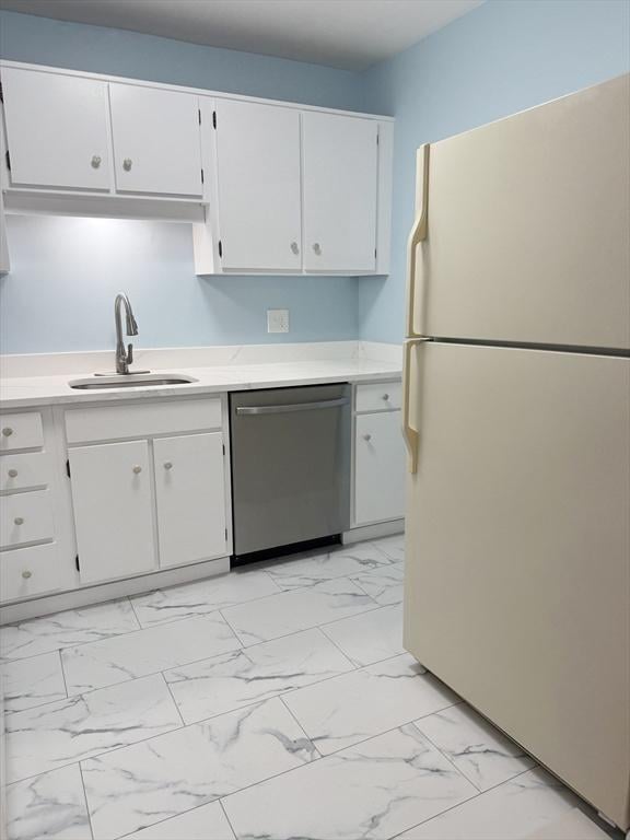 kitchen with white cabinetry, dishwasher, sink, and white fridge