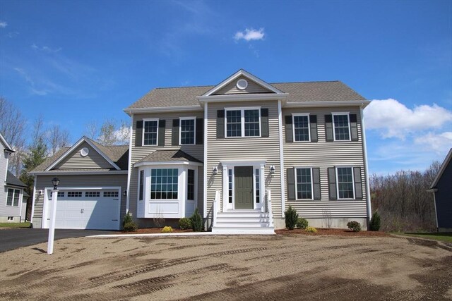 colonial house with an attached garage and driveway