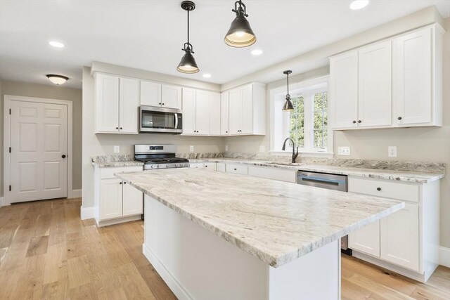 kitchen with light wood-type flooring, stainless steel appliances, white cabinets, and recessed lighting