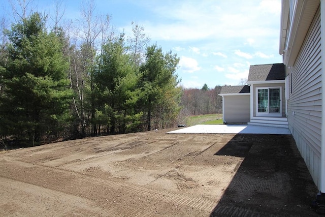 view of yard featuring entry steps and a patio