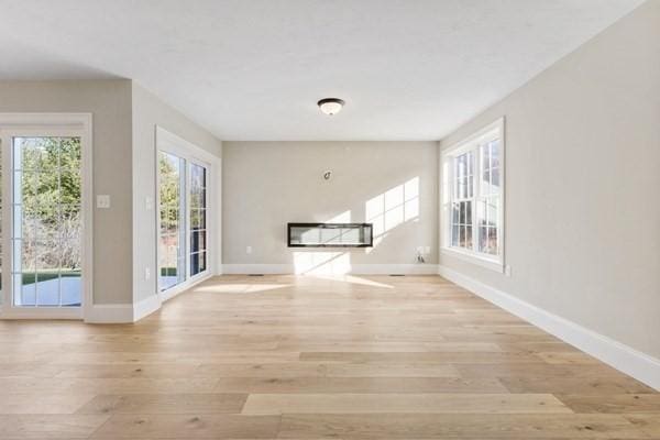 interior space featuring light wood-type flooring and baseboards