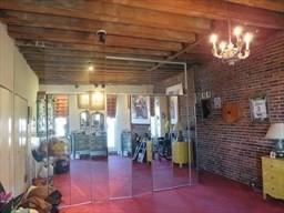 living room featuring tile patterned flooring, brick wall, and a healthy amount of sunlight