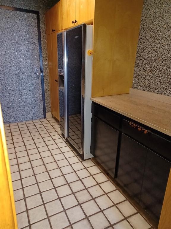 kitchen featuring appliances with stainless steel finishes, a textured ceiling, sink, and light tile patterned floors