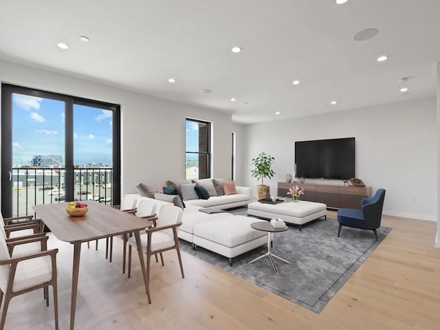 living area featuring recessed lighting, light wood finished floors, and baseboards