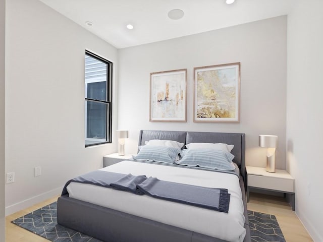 bedroom featuring wood finished floors, recessed lighting, and baseboards