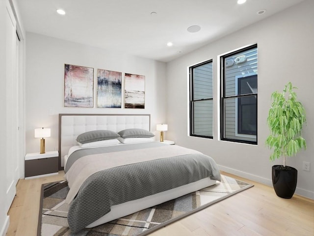 bedroom featuring light wood-style floors, recessed lighting, and baseboards
