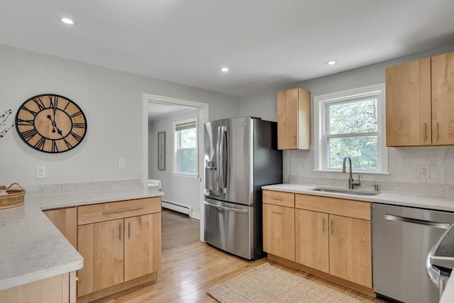 kitchen featuring a sink, appliances with stainless steel finishes, and light brown cabinetry