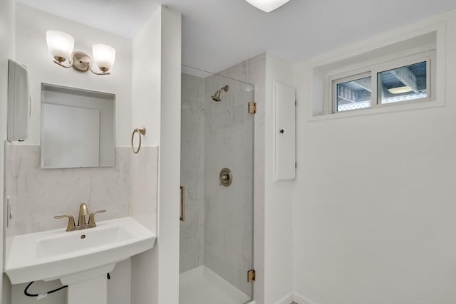 bathroom with a sink, a marble finish shower, and electric panel