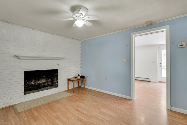 unfurnished living room featuring a ceiling fan, baseboard heating, a brick fireplace, wood finished floors, and ornamental molding