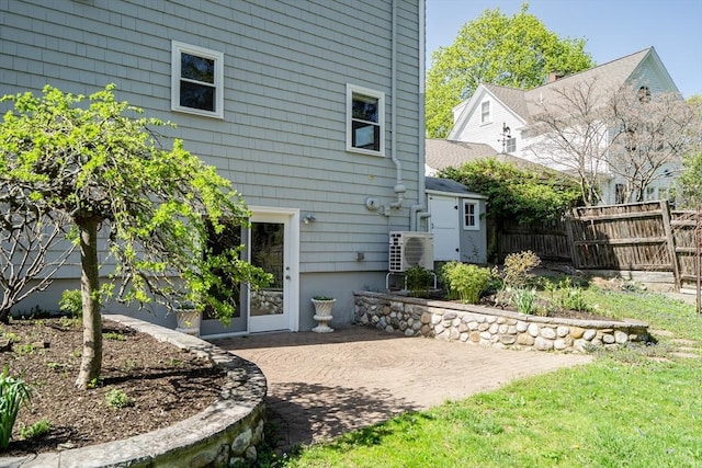 rear view of property with fence, ac unit, and a patio area