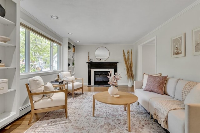 living area featuring a fireplace with flush hearth, ornamental molding, recessed lighting, and wood finished floors