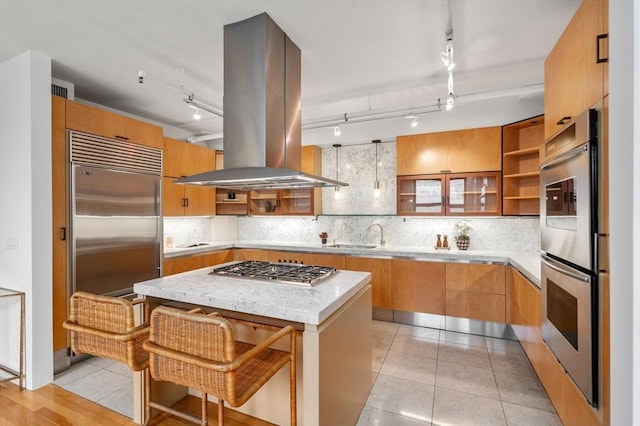 453 Washington St Unit 11E, Boston, MA 02111 - kitchen featuring open shelves, island range hood, stainless steel appliances, decorative backsplash, and modern cabinets