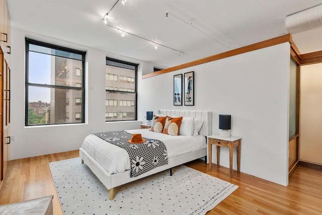 453 Washington St Unit 11E, Boston, MA 02111 - bedroom with rail lighting and light wood finished floors