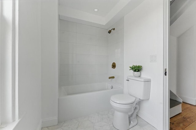 full bath featuring toilet, bathtub / shower combination, and baseboards