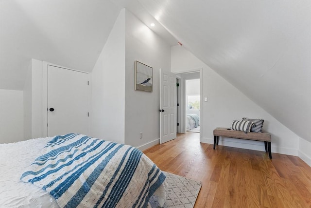 bedroom featuring vaulted ceiling, light wood-type flooring, baseboards, and recessed lighting