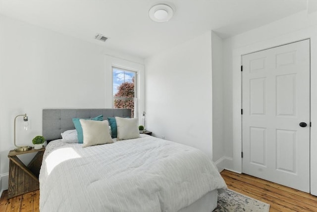 bedroom featuring wood finished floors and baseboards
