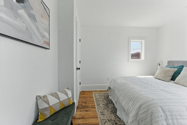 bedroom with wood finished floors and baseboards